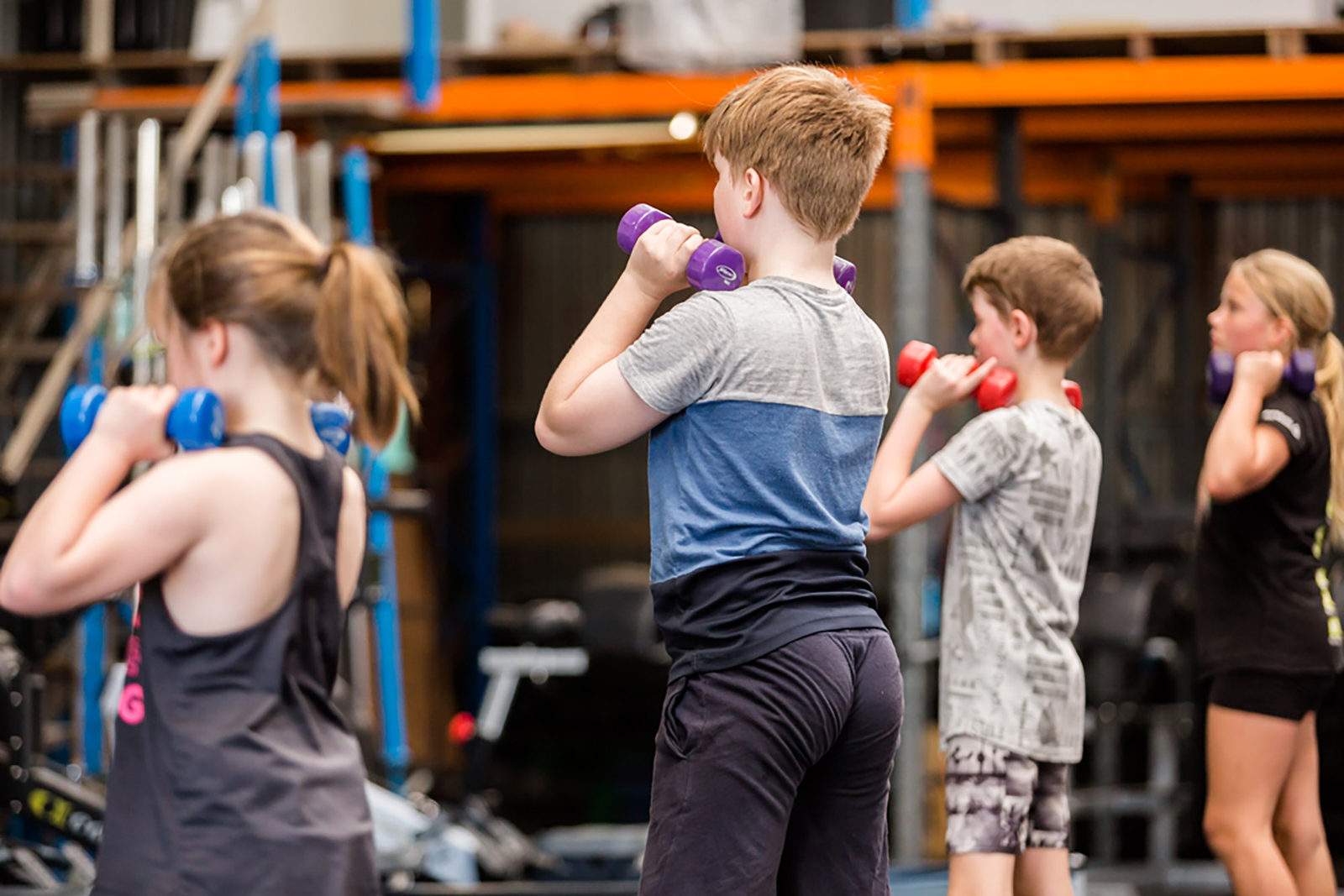 Kids training with dumbbells